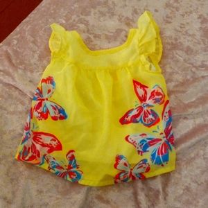 A yellow spring shirt with butterfly on them